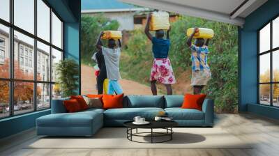 Children carrying water cans in Uganda, Africa Wall mural