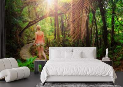 Adventurous and stunning young woman hiking in the beautiful jungle of the El Yunque national forest in Puerto Rico Wall mural