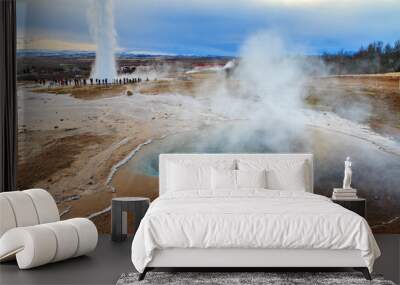 Blue pool at the Haukadalur geothermal area, part of the golden circle route, with the Strokkur Geyser in the background in Iceland Wall mural