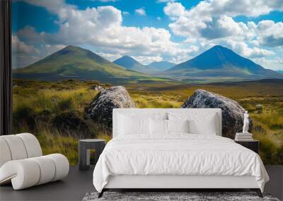 A scenic landscape with two large rocks in the foreground and a distant view of mountain peaks. Wall mural