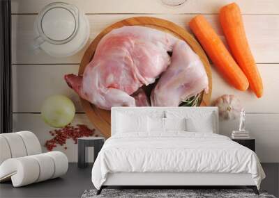 raw rabbit on a wooden Board with ingredients for stewing milk, onion, carrot, rosemary Wall mural