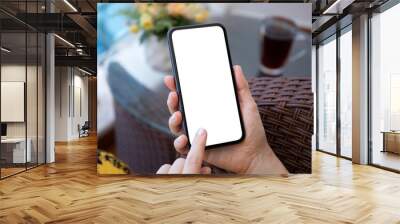 female hand hold phone with isolated screen background table house Wall mural