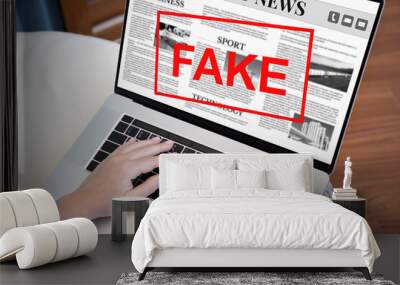 female hands laptop keyboard with world news and word fake Wall mural