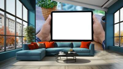 male hands holding computer tablet with isolated screen in cafe Wall mural