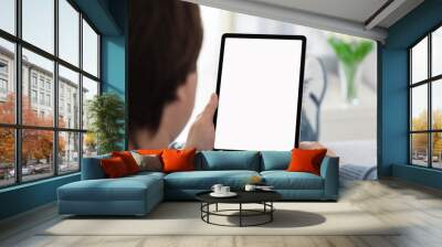 man holding in his hands computer tablet with isolated screen Wall mural