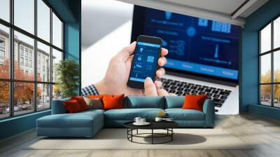 man holding phone with program smart home on the screen Wall mural