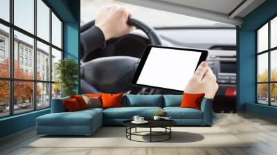 man sitting in the car and holding a tablet with isolated screen Wall mural