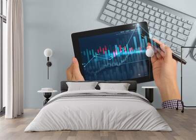 Hand holding tablet and showing holographic graphs stock market statistics gain profits Wall mural