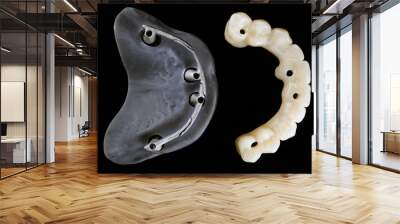 beautiful composition of a dental prosthesis made of polymer and a model with a metal bar, top view on a black background Wall mural