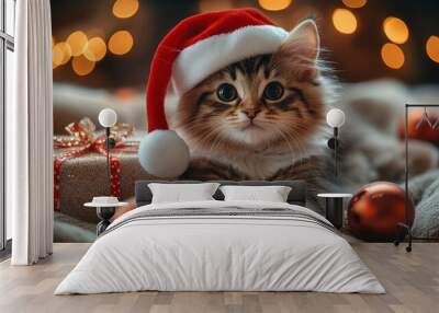 Cute kitten wearing santa hat relaxing near christmas present Wall mural