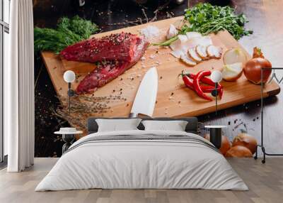 Raw meat on a cutting board with lard, pepper, onion and spices. Wall mural