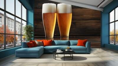 Two glasses of cold beer are standing on a wooden table Wall mural