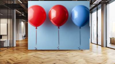 Two red balloons and one blue balloon floating on minimalist blue background Wall mural