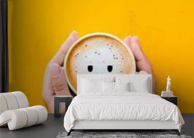 Woman holding coffee cup with sad face drawing on yellow background Wall mural