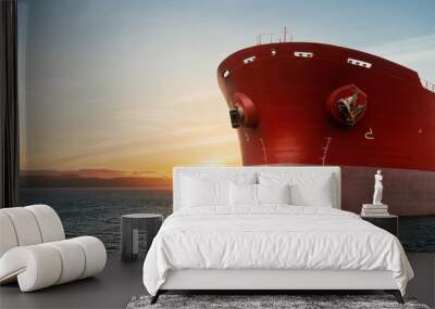 Close up of large red merchant crago ship in the ocean underway. at sunrise or sunset .Performing cargo export and import operations. Wall mural