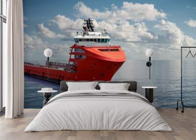 Offshore supply boat at sea during nice calm weather performing duties. Compositing technique. Wall mural