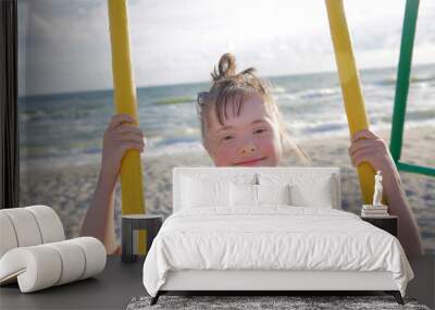 Little girl having fun on the swing Wall mural