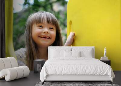 Portrait of beautiful young girl on the playground. Wall mural