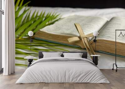 cross made from palm leaf with bible and palm leaves Wall mural