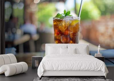 Refreshing Iced Tea with Lemon and Mint in a Tall Glass on an Outdoor Table Wall mural