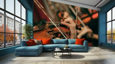 Symphony orchestra on stage, hands playing violin. Shallow depth of field, vintage style. Wall mural