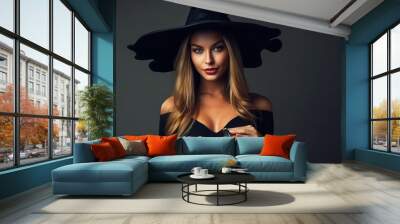 Beautiful woman dressed as witch for Halloween standing in front of isolated background - ai generative Wall mural