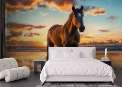 A brown horse standing on top of a sandy beach under a cloudy blue and orange sky with a sunset.  Wall mural