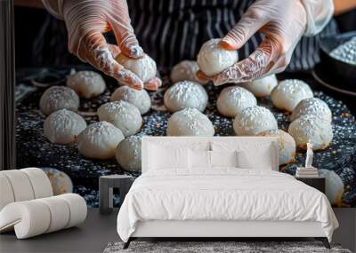 hands of cook serving a Mochi, a Japanese rice cake made from glutinous rice pounded into a sticky, chewy texture, filled with sweetened red bean paste, fruit, or ice cream Wall mural