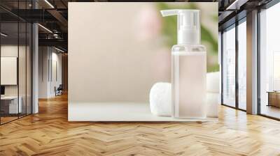 Facial foam bottle with a clear, sleek design, beauty packaging, modern and clean Wall mural