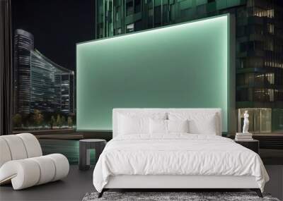 Big blank green billboard Mockup on the façade of modern high-rise building in the city at Night Wall mural