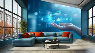 Hand reaching out to a digital interface with glowing blue data and icons. Wall mural