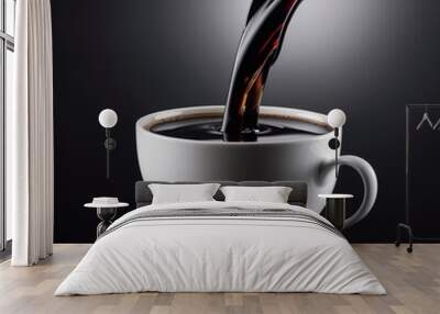 Black coffee pouring into a white cup on dark background  Wall mural