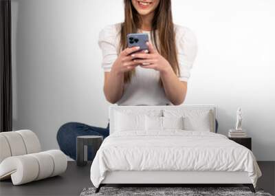 Mobile application advertisement, happy caucasian teen girl using mobile application advertisement. Texting, browsing, messaging, looking smartphone. Isolated white background, free space. Modern lady Wall mural