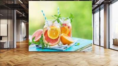 Grapefruit and orange water in glass jars in the open air. Concept for healthy eating and nutrition. Copy space. Wall mural