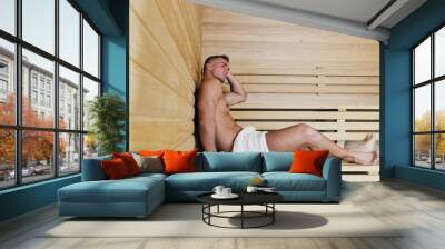 happy good looking and attractive young man with muscular body  relaxing in sauna hot Wall mural