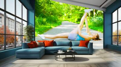 Young woman exercising, from a complete series of photos. Wall mural