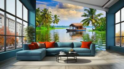 House boat in backwaters near palms at cloudy blue sky in munnar, Kerala, India Wall mural