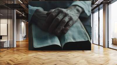 Man reading a bible, praying, worshiping, and looking up to God as a christian and spiritual person who follows Jesus and seeks assistance from a holy book on a table Wall mural