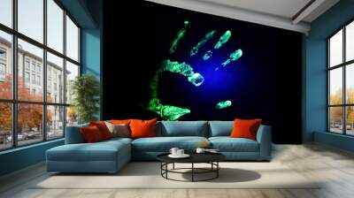 Fluorescent green hand print on black background under UV light Wall mural