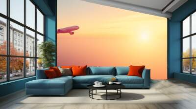 passenger airplane flying away to sky-high altitude during sunset with copy space Wall mural