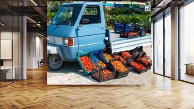 Small italian apo truck with tomatoes. Farmer sale tomatoes on the street in Italy. Wall mural