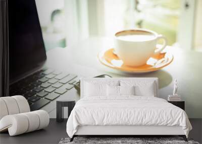 Cup of coffee and smart devices on the table close up. (Processed in vintage colour tone) Wall mural