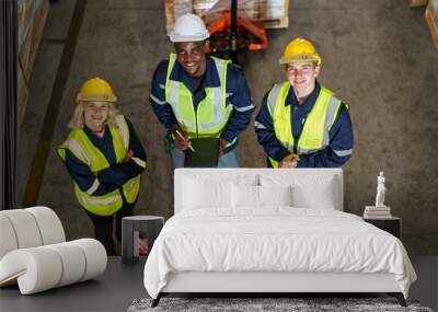 Diversity ethnicity of warehouse staff or engineer making a discussion together before start working, team of engineer in factory making a morning brief before working. Wall mural