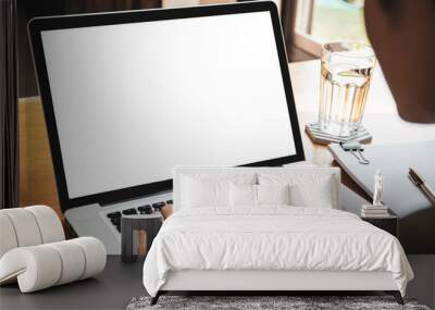 Isolation with clipping path. Young businessman working in front of the laptop computer during the quarantine or self-isolation. Businessman using notebook computer to work. Empty notebook screen. Wall mural