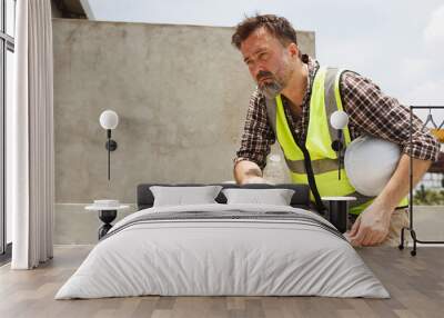 Male worker working in a very hot day. Wall mural