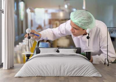 Senior professional quality control officer inspecting the manufacturing line and computer system in the beverage bottling factory. Wall mural