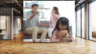 unhappy Asian family, critical problem of father and mother arguing with their daughter sitting and crying. Wall mural