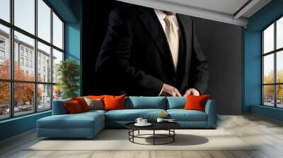 businessman buttoning jacket, getting dressed, on dark Wall mural