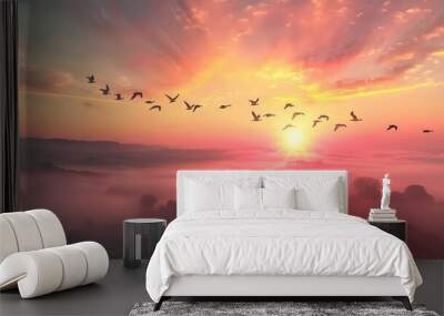 flock of birds flying over the sunset Wall mural