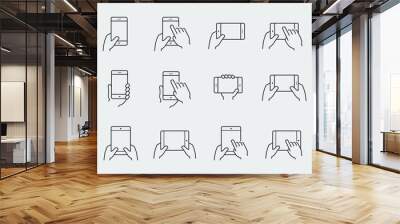 Icon set of hands holding smartphone and tablet Wall mural